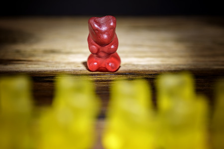 gummy bear all against one yellow against redの写真素材