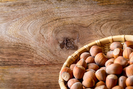 hazelnut in basket on wood