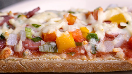 baked baguette with salami, cheese and vegetable