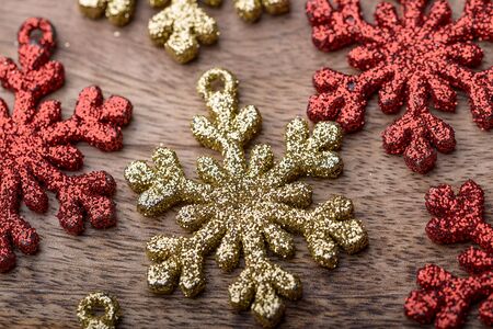 red and gold snowflake christmas decorations on woodの写真素材