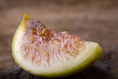 slice of fig isolated on wooden backgroundの写真素材