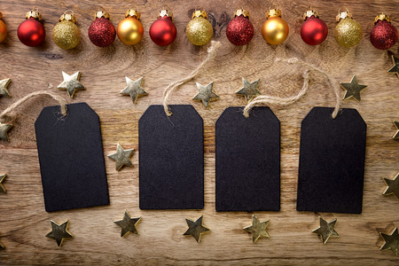 four blackboard with gold star and red and gold christmas balls on woodの写真素材