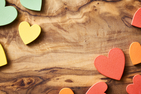 olive wood with multicolored wooden hearts for backgroundの写真素材