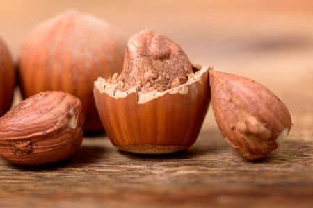 macro and hazelnut nutshell on wooden table