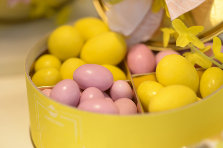 delicious chocolate eggs colored pink and yellow in Their containersの写真素材