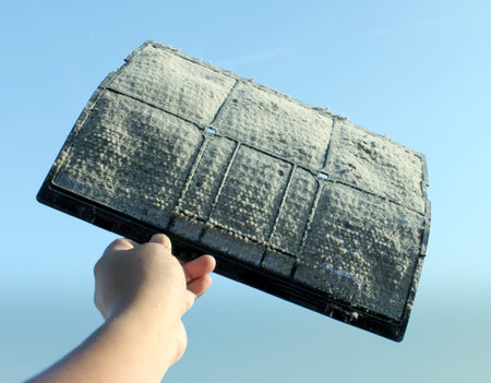 Air conditioner filter dust with hand in blue screen