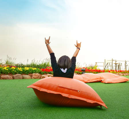 women show love hand sign take picture  from back shotの写真素材