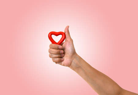 like hand sign with red heartの写真素材