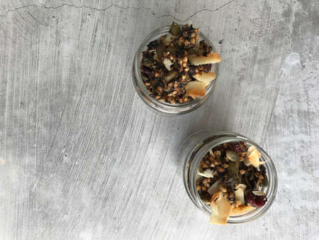 Overhead photo of two glass jars with granolaの写真素材
