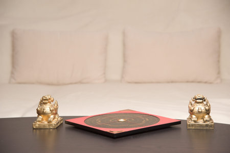 An asian symbol and a Feng Shui compass on a table