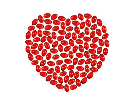 The image of heart from red pills on the isolated white backgroundの写真素材