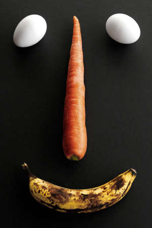 face made out of eggs, banana and carrotの写真素材