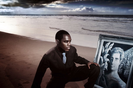 Young man on the beach in suit