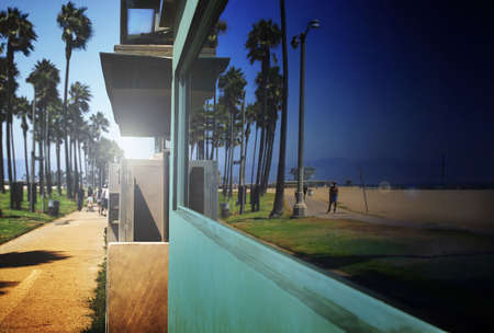 reflection of beach in a building's windowの写真素材