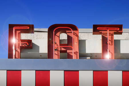 red and white fat sign against blue skyの写真素材