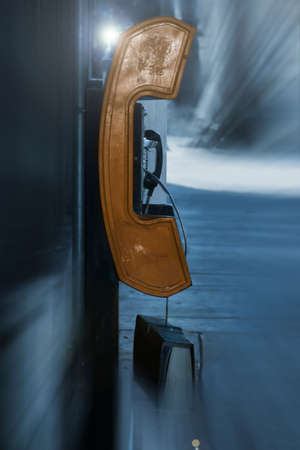 rusted old payphone on a city street backgroundの写真素材