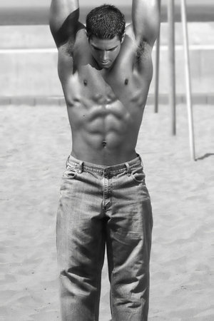Black and white photo of young fit man hanging