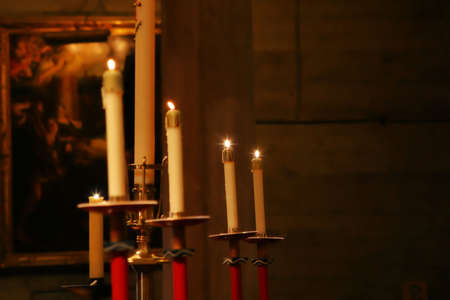 Lit candles displayed in churchのeditorial素材