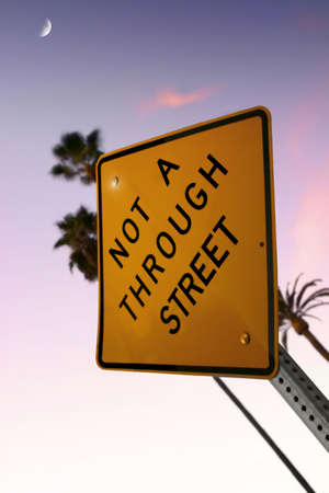 Sign reading "Not a Through Street" with pink skyの写真素材