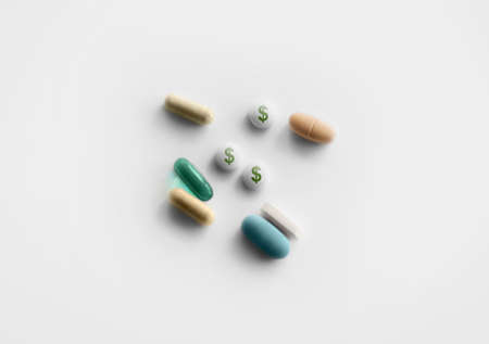 Prescription pills on white background with dollar signsの写真素材