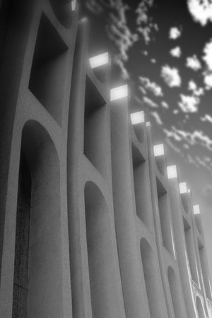 Architectural detail of a unique art deco style building and drmatic clouds