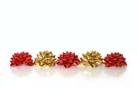 Line of red and gold bows on white backgroundの写真素材