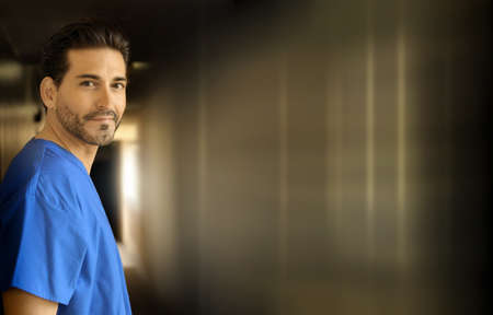 Portrait of a young smiling doctor in corridorの写真素材