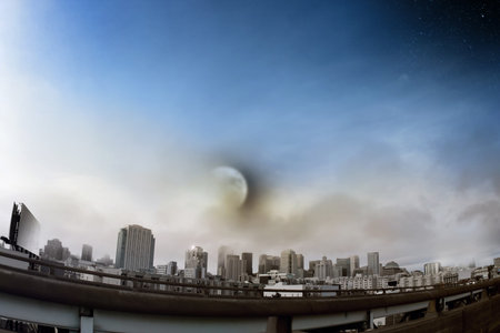Cityscape wide angle shot of skyline viewed from freeway with moon and stars above
