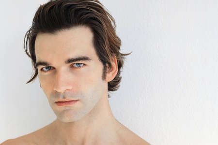 Close up portrait of a young man against white backgroundの写真素材