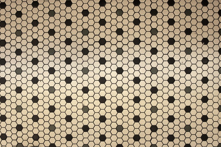 Background of vintage old tile in black and off white geometric shapes