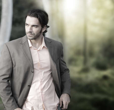 Portrait of elegant man in suit outdoors with lots of copy spaceの写真素材