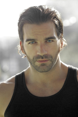 Close-up portrait of a young good looking male model outdoors