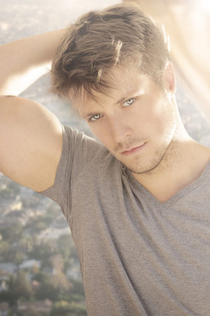 Natural portrait of a beautiful young male model with lots of light