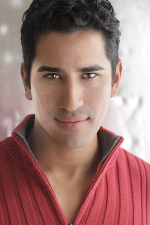 Natural close-up portrait of a casual young man against modern background