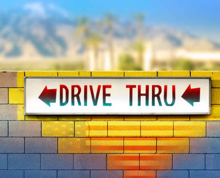 Colorful image of an old drive thru sign on wallの写真素材