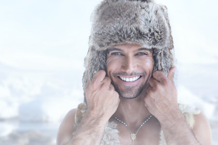 Fashion portrait of smiling male model in fur hat