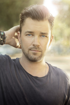 Casual outdoor portrait of a masculine handsome male model