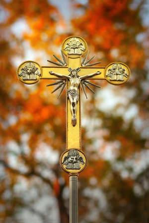 Beautiful glowing ornate golden crucifix of Jesus on the cross with natural の写真素材