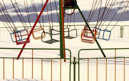 Carousel in winter park on a sunny dayの写真素材