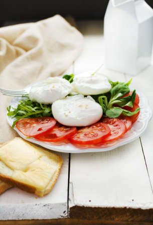 Breakfast with poached eggs seasoned with smoked saltの写真素材