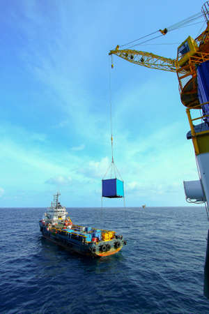Crane operation with supply boatの写真素材