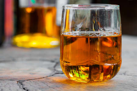 Golden Brown Whisky on the rocks in a glassの写真素材