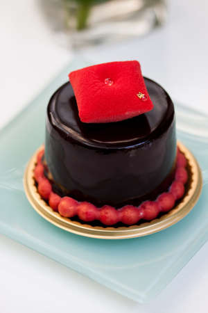 Piece of chocolate cake with icing on white isolated backgroundの写真素材