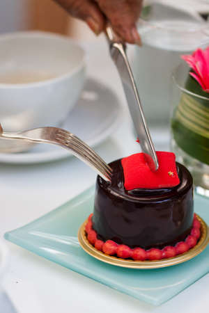 Piece of chocolate cake with icing on white isolated backgroundの写真素材