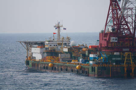 Large crane vessel installing the platform in offshore,crane barge doing marine heavy lift installation works in the gulf or the seaのeditorial素材