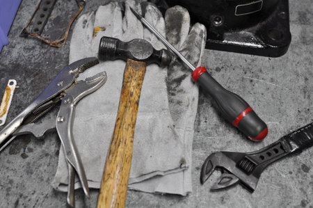 Dirty set of hand tools on table, Assorted work tools on table