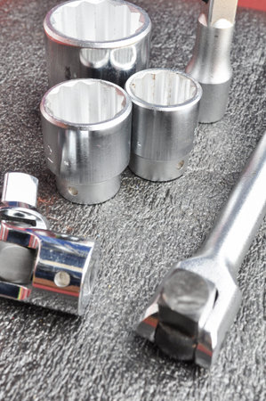 Set of chromeplated wrench dadoes set close up, on a wood background 