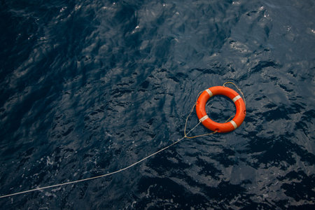Lifebuoy in a stormy blue sea, Lifebuoy in blue sea, safety equipment in offshore or marine の写真素材