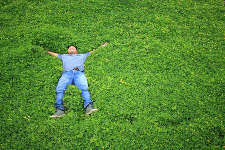 Man on the grass or people sleep in the gardenの写真素材