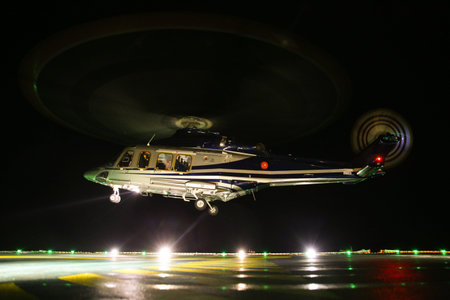 Helicopter landing in offshore oil and gas platform on deck or parking area. Helicopter night flight...
